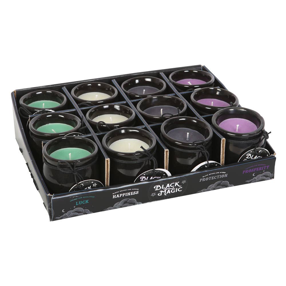 Box of Black Magic candles with various scents on a white background