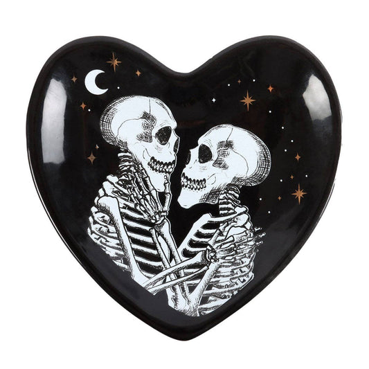 Heart-shaped black trinket dish with skeletons embracing and stars on a white background