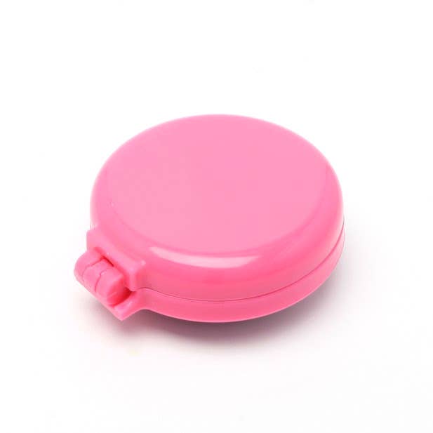 Pink folding hairbrush with built-in mirror