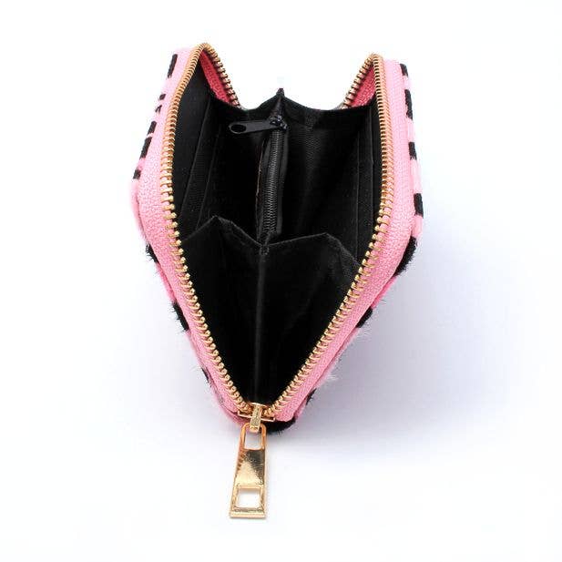 Pink leopard print purse opened to demonstrate inside