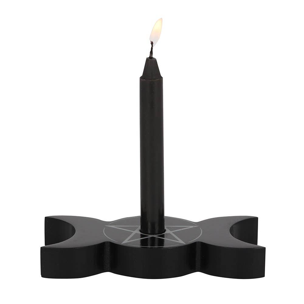 Black spell candle holder with a lit candle on a white background