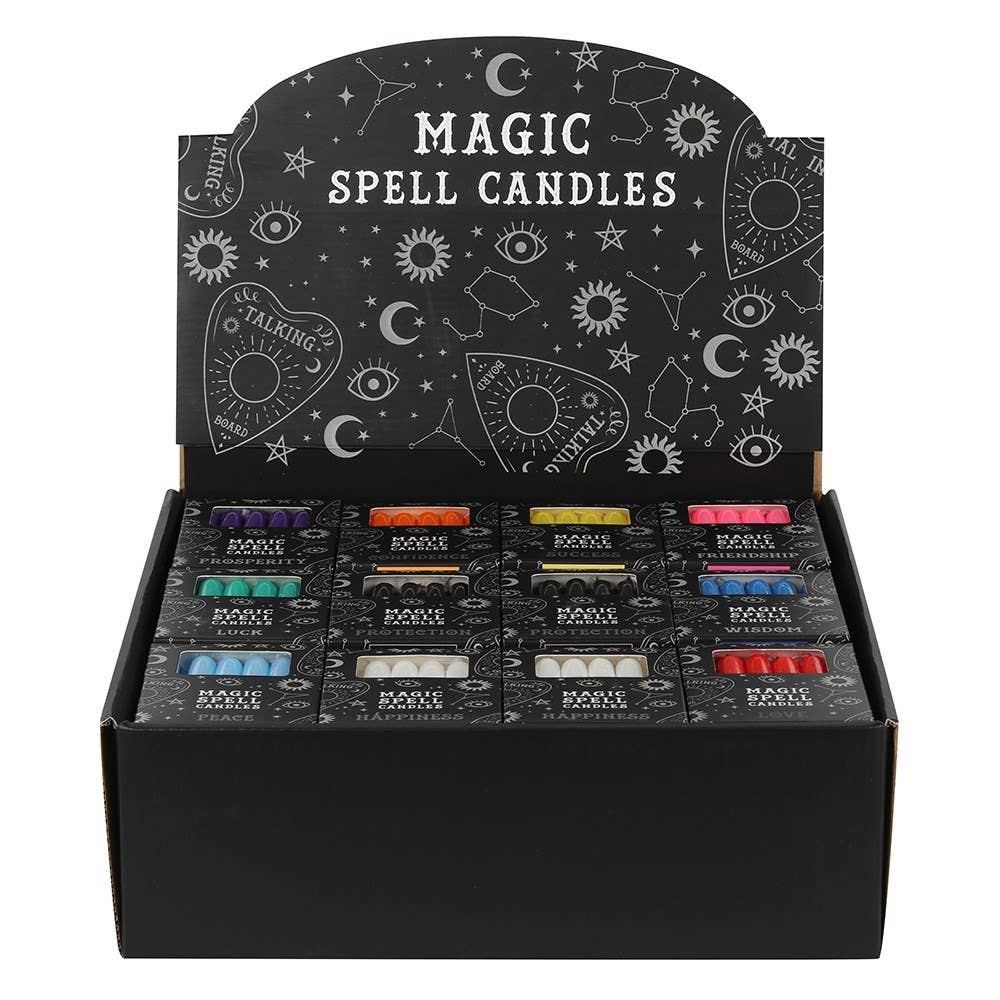 Display box of 'Magic Spell Candles' with various colored candles inside.