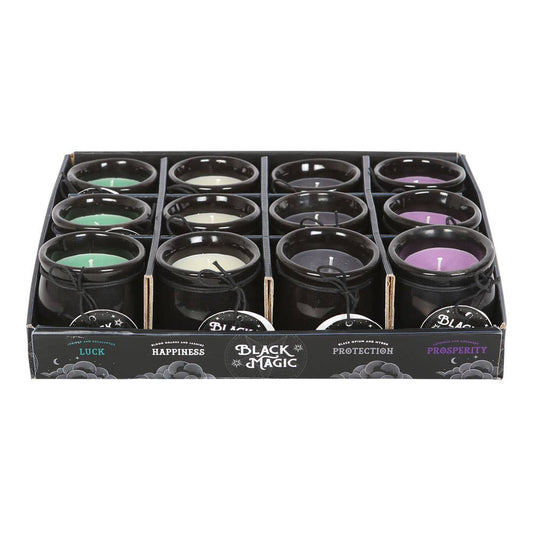 Box of black candles with various colors and labels on a white background