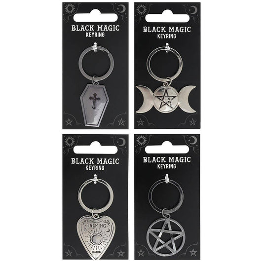 Four black carded keychains with black magic designs on a white background