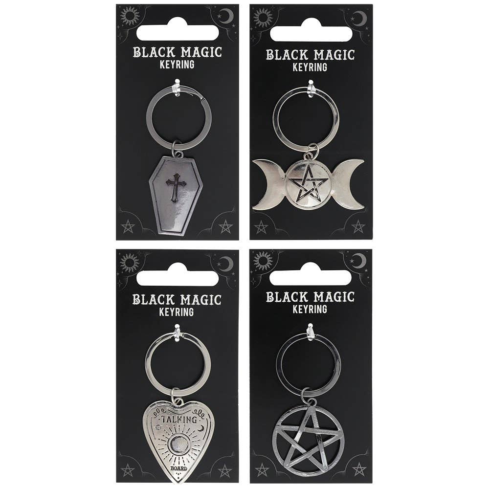 Four black carded keychains with black magic designs on a white background