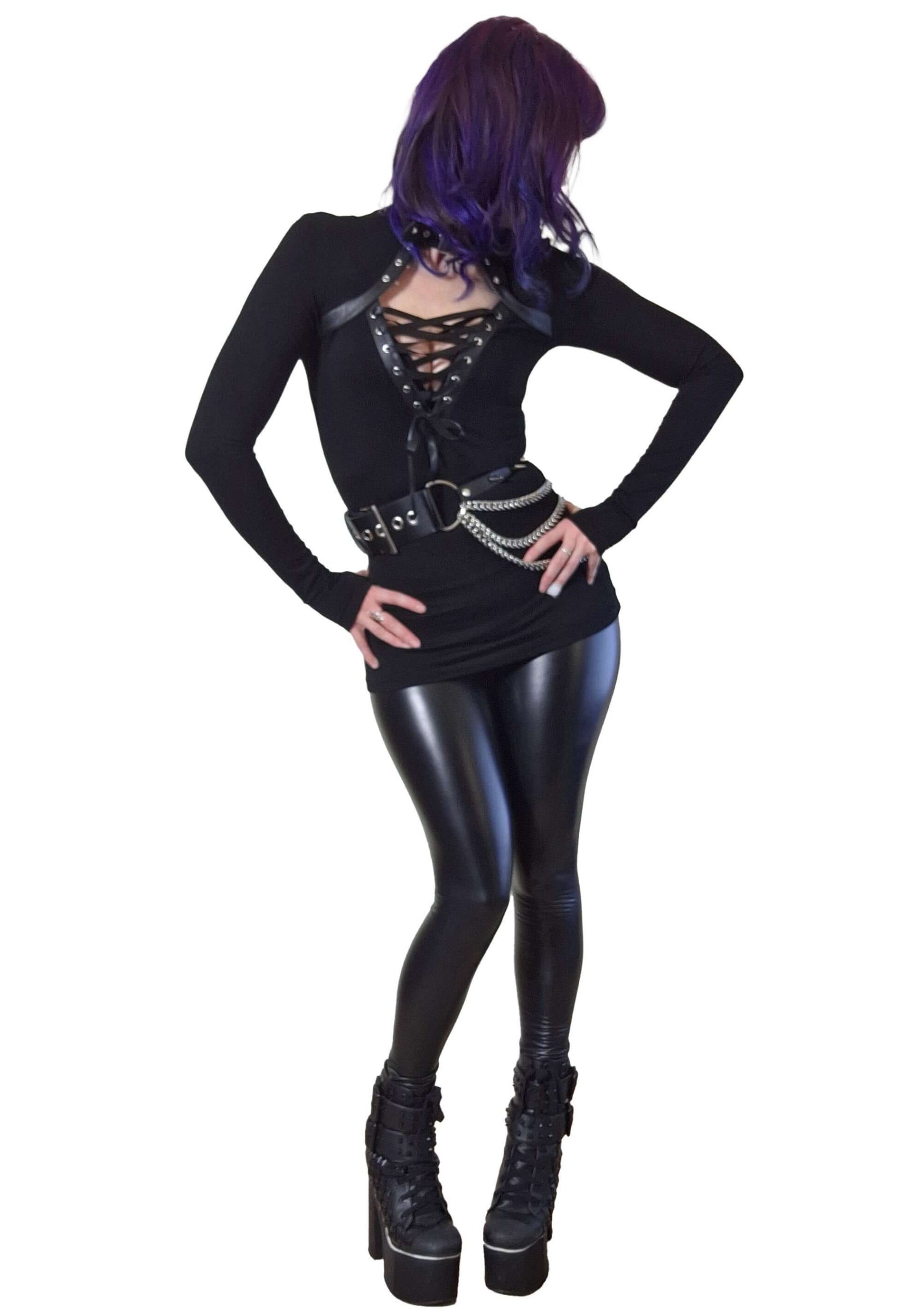 Person wearing a black outfit with a belt and high boots on a white background