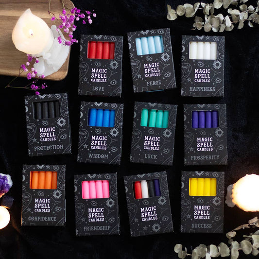 Collection of 'Magic Spell Candles' in various colors with corresponding labels on a dark background.